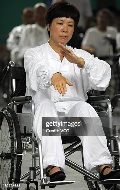 Woman with lower-limb disabilities sitting in wheelchairs plays Tai Chi Chuan in Xuanhua District on July 15, 2015 in Zhangjiakou, Hebei Province of...