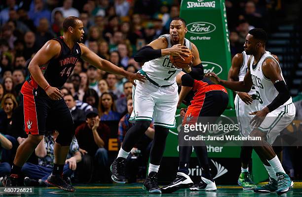 Jared Sullinger of the Boston Celtics grabs a rebound in front of Chuck Hayes of the Toronto Raptors in the second quarter during the game at TD...