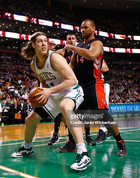 Kelly Olynyk of the Boston Celtics stands underneath the basket in front of Chuck Hayes of the Toronto Raptors in the second quarter during the game...