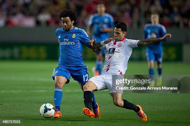 Marcelo of Real Madrid CF competes for the ball with Vctor Machin alias Vitolo of Sevilla FC during the La Liga match between Sevilla FC and Real...