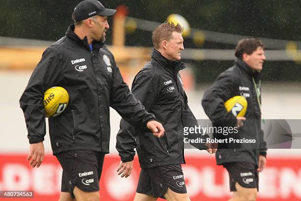 Anthony Rocca, along with Coach Nathan Buckley and Robert Harvey look on during a Collingwood Magpies AFL training session at Westpac Centre on March...