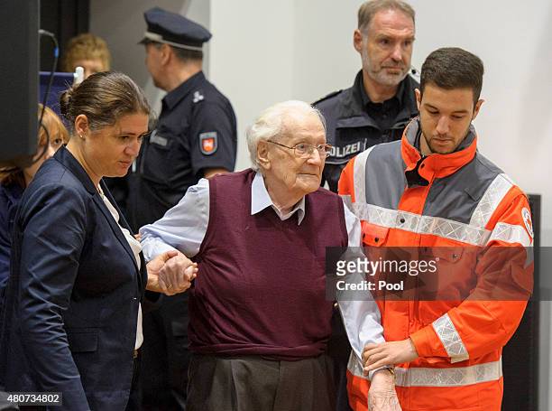 Oskar Groening a former member of the Waffen-SS who worked at the Auschwitz concentration camp during World War II, is helped into court by lawyer...
