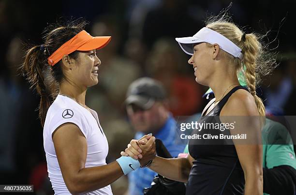 Na Li of China shakes hands at the net after her straight sets victory against Caroline Wozniacki of Denmark during their quarter final round match...