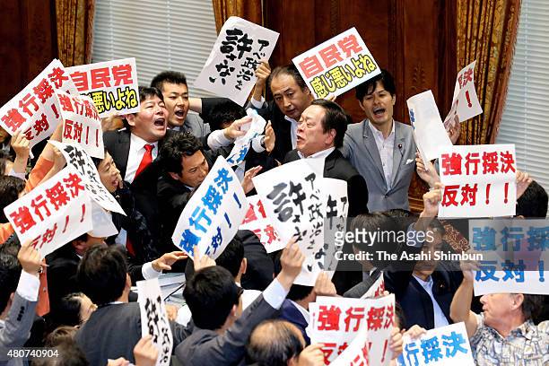 Lower House special committee deliberating security legislation Chairman Yasukazu Hamada calls for vote while opposition party lawmakers shout out...