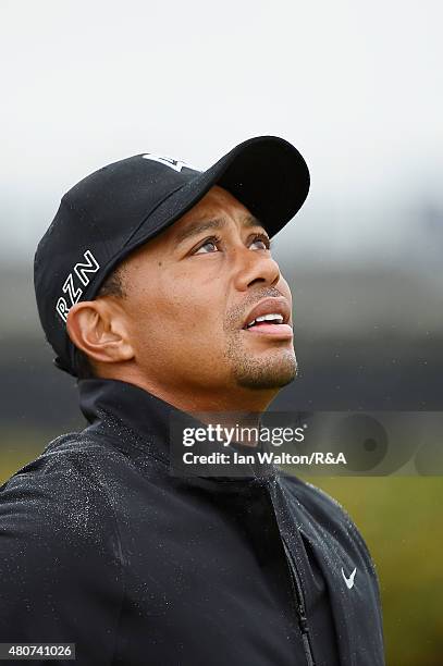 Tiger Woods of the United States looks up at the sky as the rain falls on the practice range ahead of the 144th Open Championship at The Old Course...