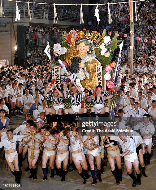 The first float 'Daikoku-Nagare' rushes through Seido Street of Kushida Jinja Shrine during the Hakata Gion Yamakasa festival on July 15, 2015 in...