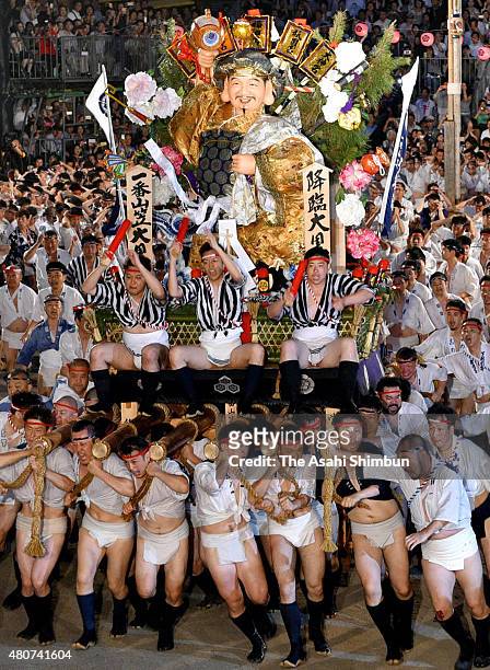 The first float 'Daikoku-Nagare' rushes through Seido Street of Kushida Jinja Shrine during the Hakata Gion Yamakasa festival on July 15, 2015 in...