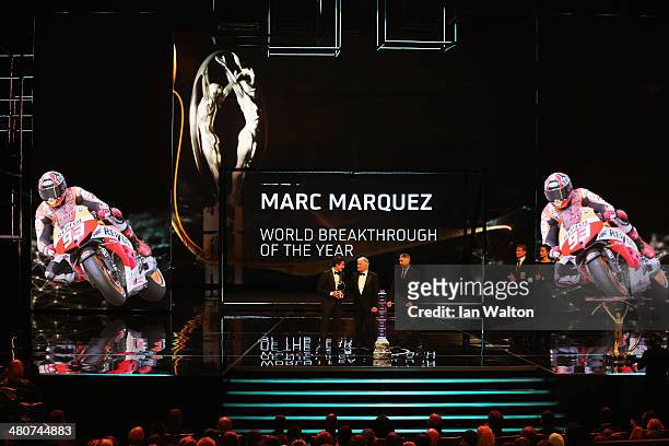 Motor cyclist Marc Marquez accepts his Laureus World Breakthrough of the Year award from Laureus Academy member Giacomo Agostini and Mick Doohan...