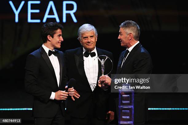 Motor cyclist Marc Marquez accepts his Laureus World Breakthrough of the Year award from Laureus Academy members Giacomo Agostini and Mick Doohan...