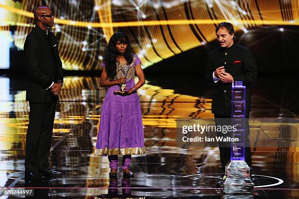 Matthew Spacie with Parvati speaks on stage after winning the Sport for Good award for the Magic Bus project as Laureus Academy Chairman Edwin Moses...