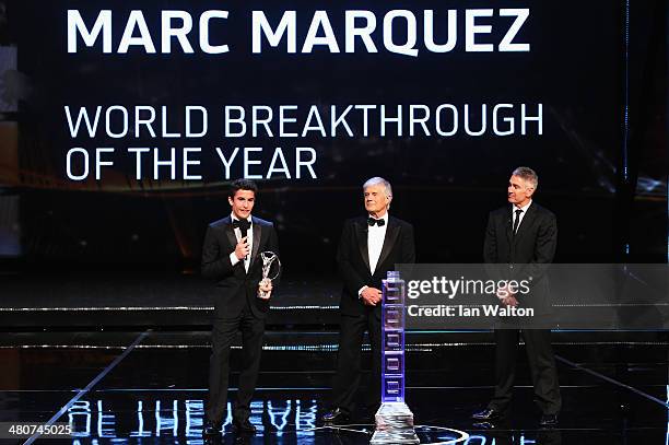 Motor cyclist Marc Marquez speaks with his Laureus World Breakthrough of the Year award from Laureus Academy members Giacomo Agostini and Mick Doohan...
