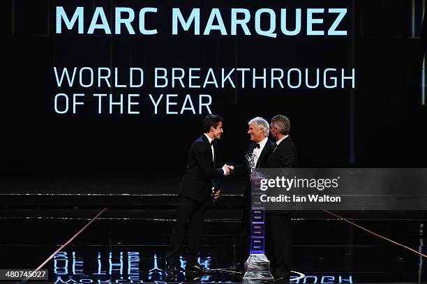 Motor cyclist Marc Marquez accepts his Laureus World Breakthrough of the Year award from Laureus Academy members Giacomo Agostini and Mick Doohan...