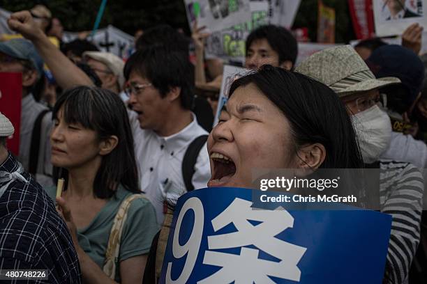 Woman protests outside the National Diet on July 15, 2015 in Tokyo, Japan. Protesters gathered after the ruling Liberal Democratic Party pushed the...