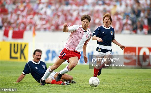 Denmark forward Michael Laudrup is challenged by Willie Miller and Gordon Strachan during the FIFA 1986 World Cup match between Denmark and Scotland...