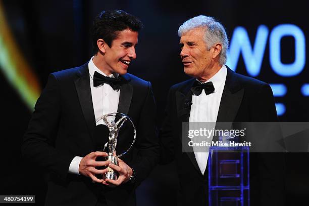 Motor cyclist Marc Marquez accepts his Laureus World Breakthrough of the Year award from Laureus Academy member Giacomo Agostini during the 2014...