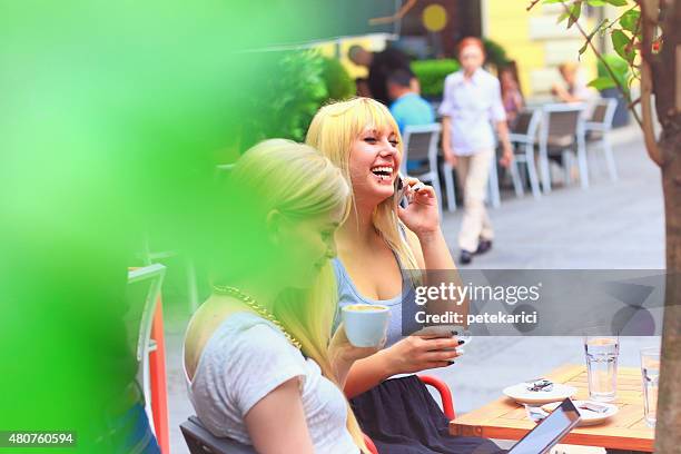 happy woman talking on the phone in a cafe - knez mihailova street stock pictures, royalty-free photos & images
