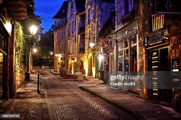 quiet street scene in sarlat france at dusk - sarlat stock pictures, royalty-free photos & images