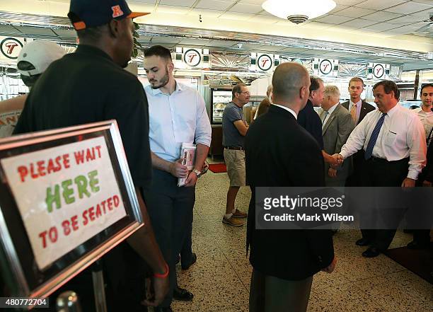 Republican presidentail candidate, New Jersey Gov. Chris Christie greets patrons during a campaign stop with Maryland Gov. Larry Hogan at the Double...