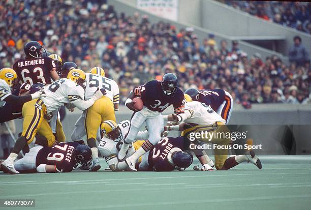 Walter Payton of the Chicago Bears carries the ball against the Green Bay Packers during an NFL football game circa 1984 at Soldier Field in Chicago,...