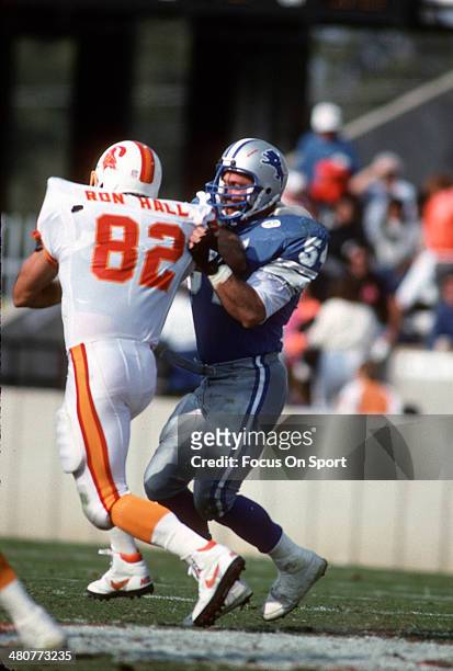 Chris Spielman of the Detroit Lions tackles Ron Hall of the Tampa Bay Buccaneers during an NFL football game November 10, 1991 at Tampa Stadium in...