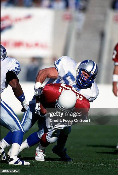 Chris Spielman of the Detroit Lions tackles Larry Centers of the Phoenix Cardinals during an NFL football game December 12, 1993 at Sun Devil Stadium...