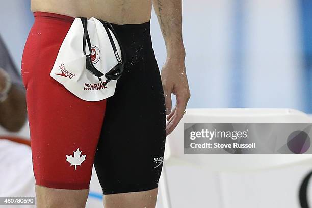 Olympic medalist Ryan Cochrane of Canada watches the final leg of the men's 4 x 200 metre freestyle relay in the preliminaries of the the second day...