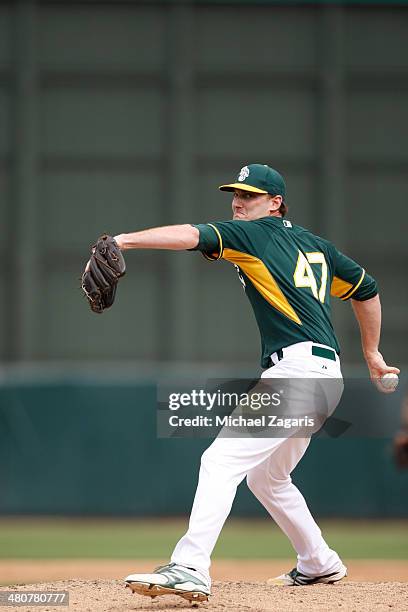 Philip Humber of the Oakland Athletics pitches during a spring training game against the Milwaukee Brewers at Phoenix Municipal Stadium on February...