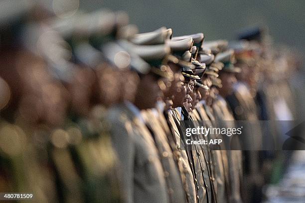 Members of Myanmar's military attend a ceremony to mark the 69th anniversary of Armed Forces Day in Myanmar's capital Naypyidaw on March 27, 2014....