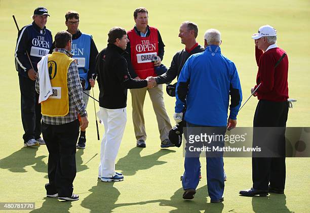 Sandy Lyle of Scotland, Sir Bob Charles of New Zealand David Duval of the United States and Justin Leonard of the United States shake hands on the...