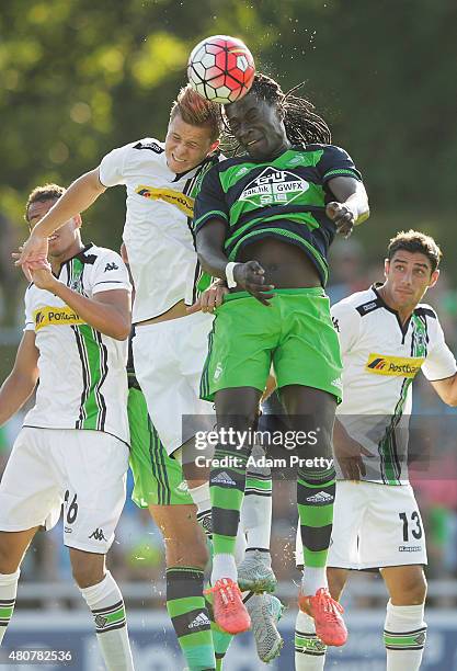 Bafetimbi Gomis of Swansea is challenged by Nico Elvedi of Borussia Moenchengladbach during the City Preseason Friendly between Borussia...