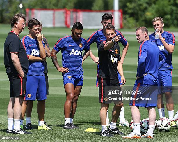 Assistant coach Albert Stuivenberg and Wayne Rooney of Manchester United in action during a first team training session as part of their pre-season...