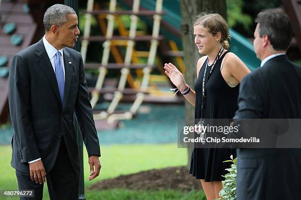 President Barack Obama says goodbye to Vice President Joe Biden's granddaughter Finnegan Biden before departing the White House on the South Lawn...