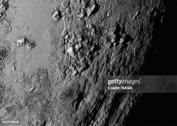 In this handout provided by the National Aeronautics and Space Administration , a close-up image of a region near Pluto's equator shows a range of...