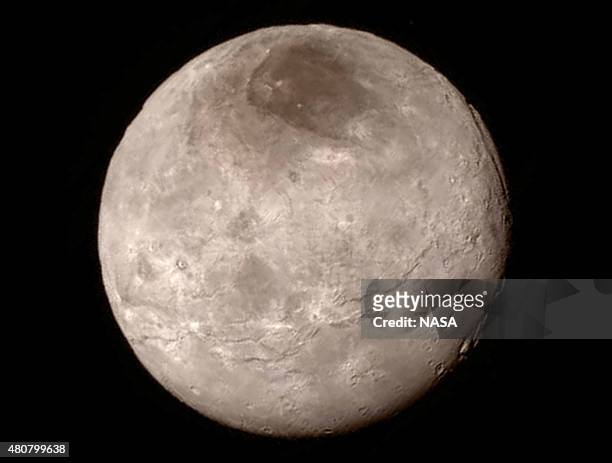 In this handout provided by the National Aeronautics and Space Administration , Pluto's largest moon Charon is shown from a distance of 289,000 miles...