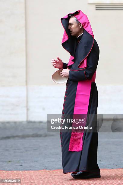 Wind blows the garments of Prefect of the Pontifical House and former personal secretary of Pope Benedict XVI, Georg Ganswein as he waits to greet US...