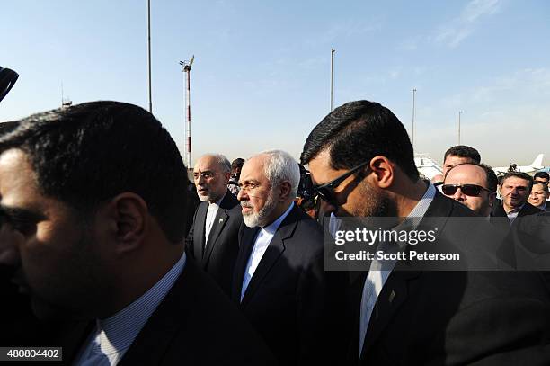 Iranian Foreign Minister Mohammad Javad Zarif and the head of Iran's Atomic Energy Organization Ali Akbar Salehi, touch down on Iranian soil after...