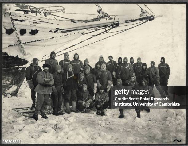 Officers and crew of the 'Endurance' - the shore party group pose under the bow of the 'Endurance' at Weddell Sea Base during the Imperial...