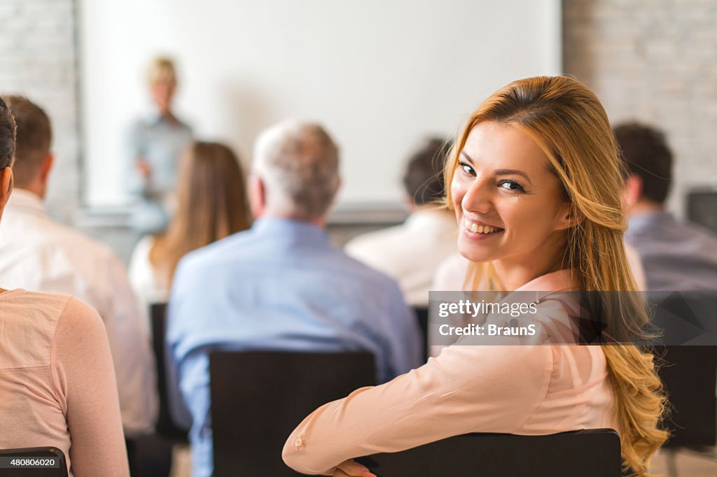 Young happy businesswoman attending a business education event.
