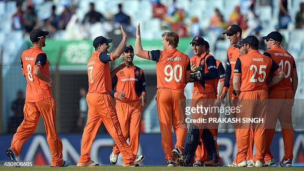 Netherlands bowler Logan van Beek celebrates the wicket of South Africa batsman AB de Villiers with teammates during the ICC World Twenty20...