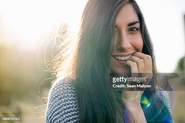 portrait of young woman with long brown hair, smiling - shy stock pictures, royalty-free photos & images
