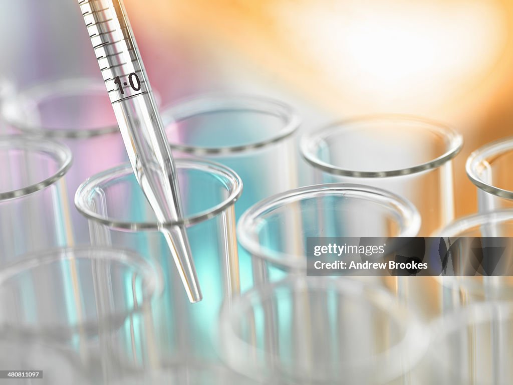 A graduated pipette being inserted into test tube