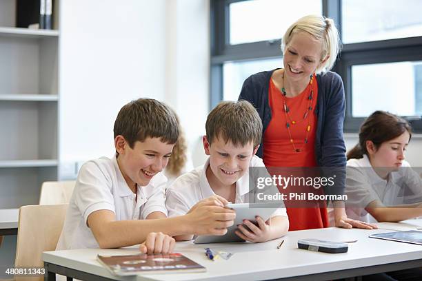 schoolchildren working in class with teacher - cardigan wales stock pictures, royalty-free photos & images