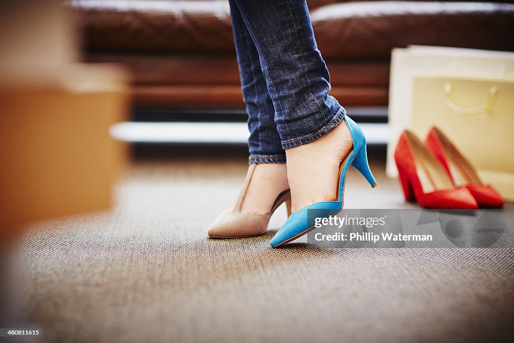 Woman trying on high heeled shoes