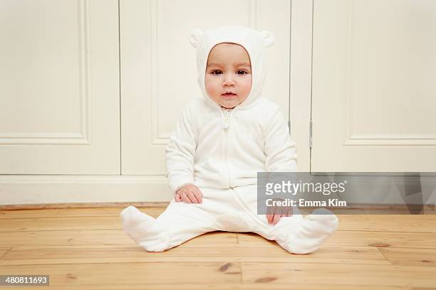 baby sitting wearing bear babygro - babygro stock pictures, royalty-free photos & images