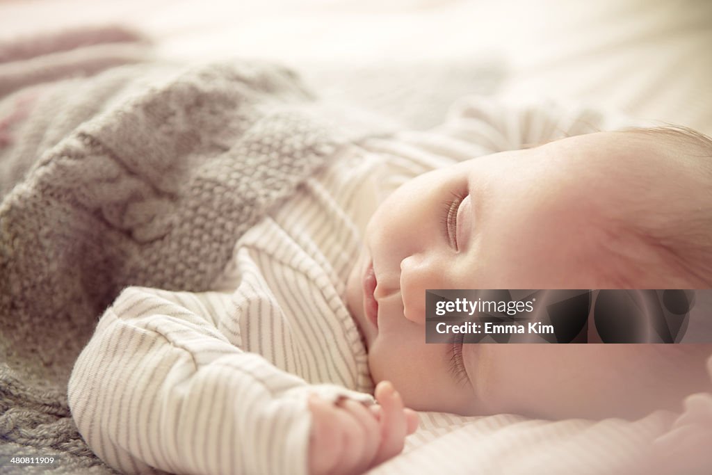 Two month old baby boy asleep in crib