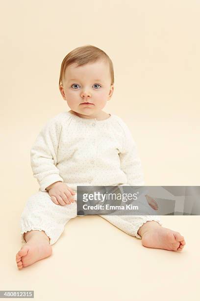 studio portrait of baby girl staring at camera - baby studio stock pictures, royalty-free photos & images