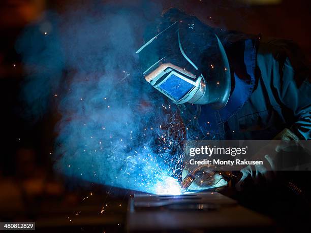 welder using oxyacetylene torch in factory - soldar fotografías e imágenes de stock