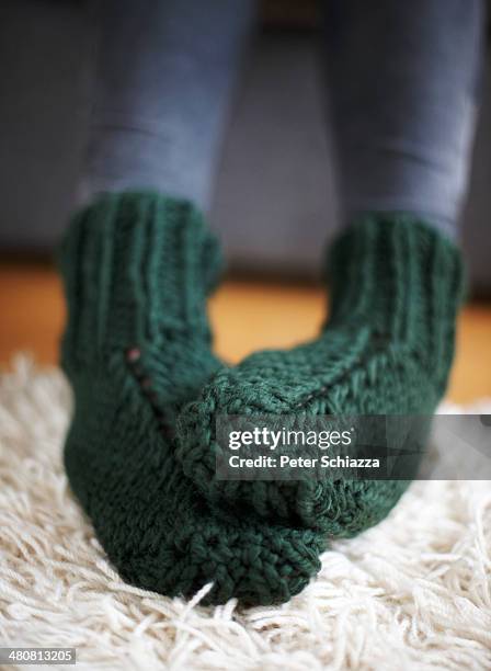 pair of feet in green knitted socks - teen stockfoto's en -beelden