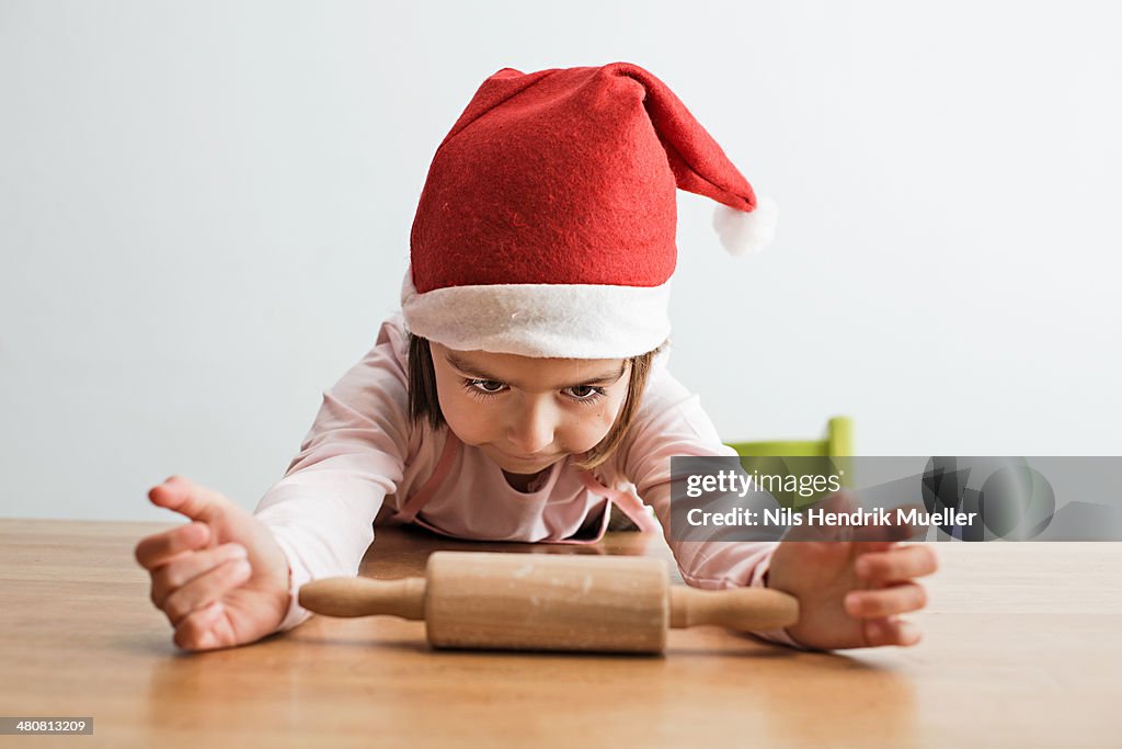 Girl staring at rolling pin