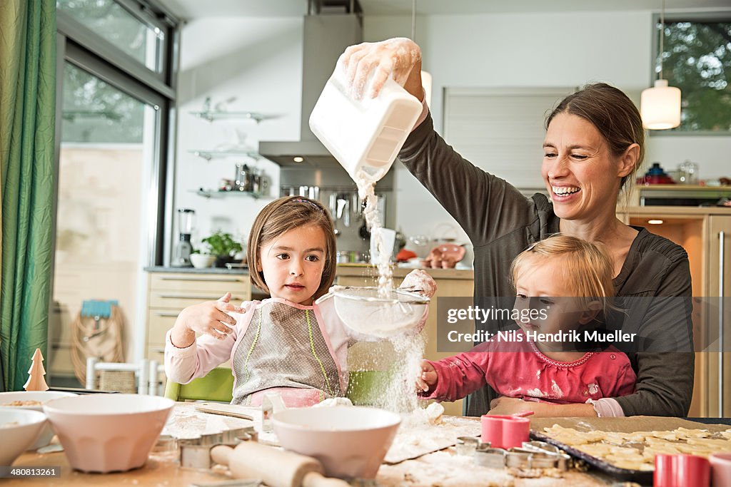 Mother and children baking in kitchen